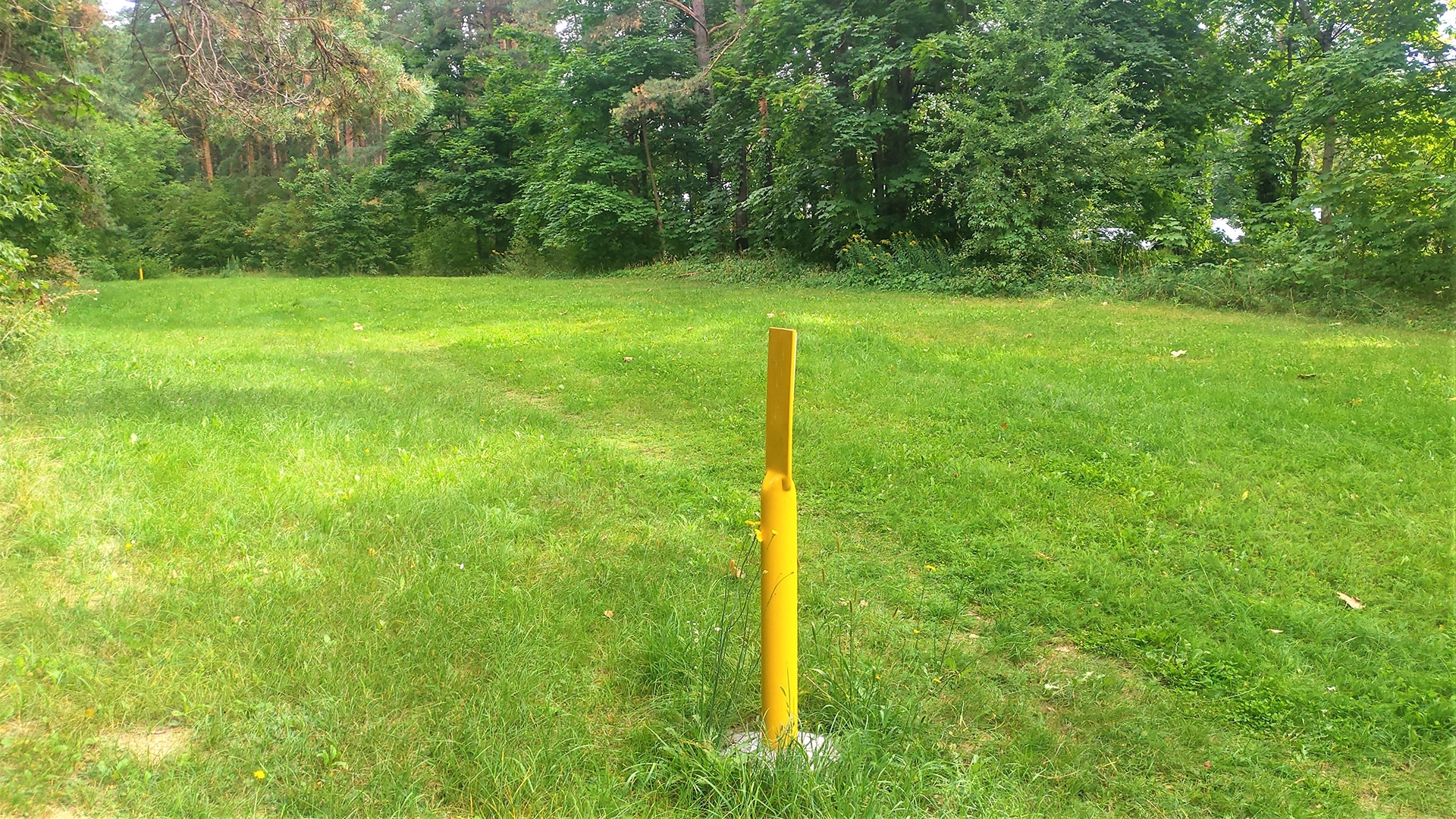 Underground pipeline right of way with yellow poles set up to mark the pipeline